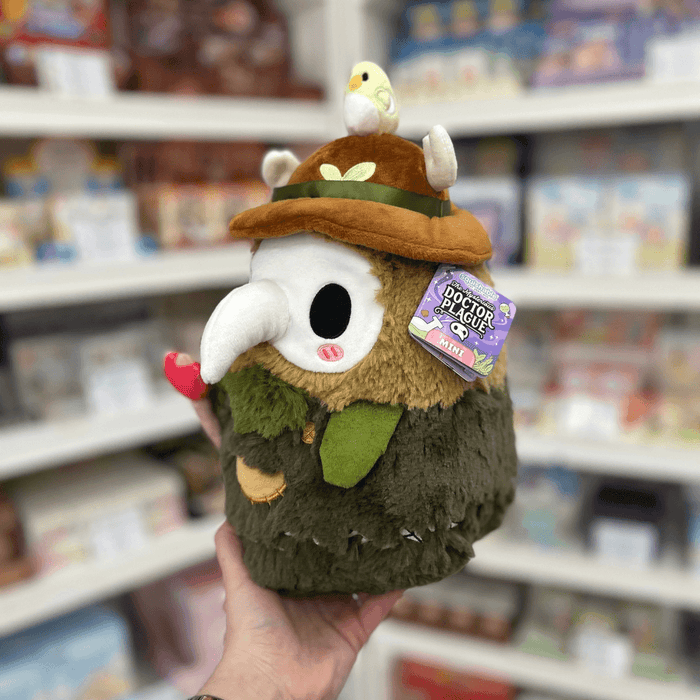 Mini Squishable Woodland Plague Doctor plush toy held in hand with tag visible