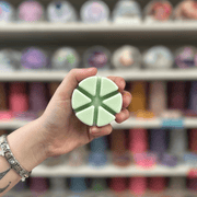 Mint Choc Chip green segmented wax melt held in hand