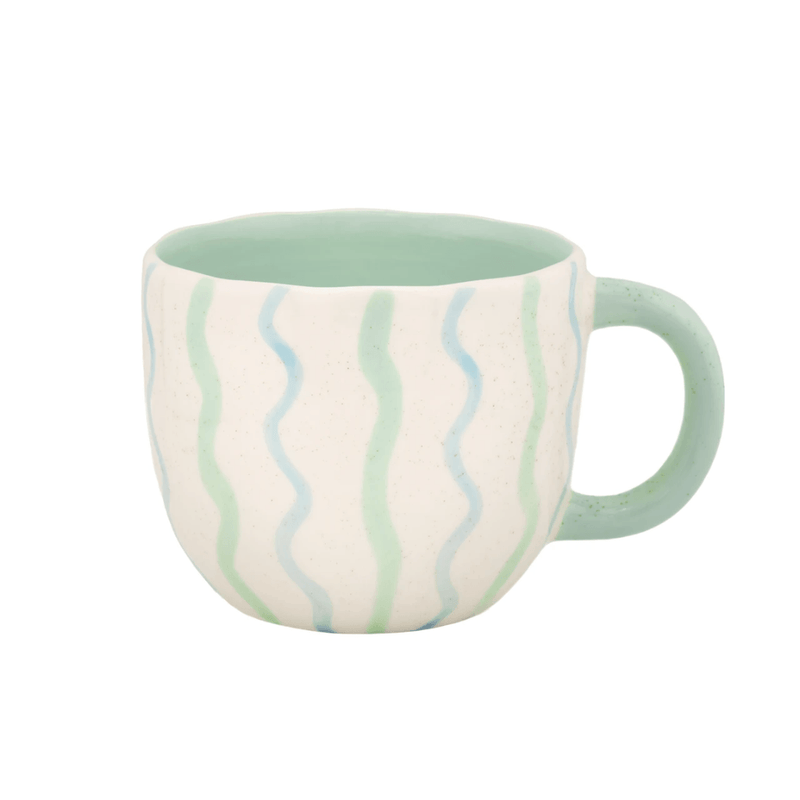 Mint green Surprise Penguin Mug with blue and green wavy stripe design