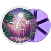 Moonlit Forest wax melt pot with six purple segments and moonlit woodland label