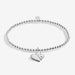 Full view of the Joma Jewellery A Little Mother & Son Bracelet, silver-plated beaded stretch Bracelet with double heart charm.