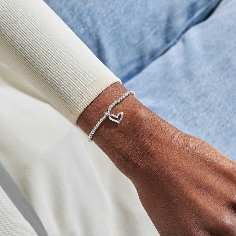 Silver-plated Joma Jewellery beaded Bracelet worn on wrist with sparkly heart charm, Love You Mum Mother’s Day Bracelet gift.