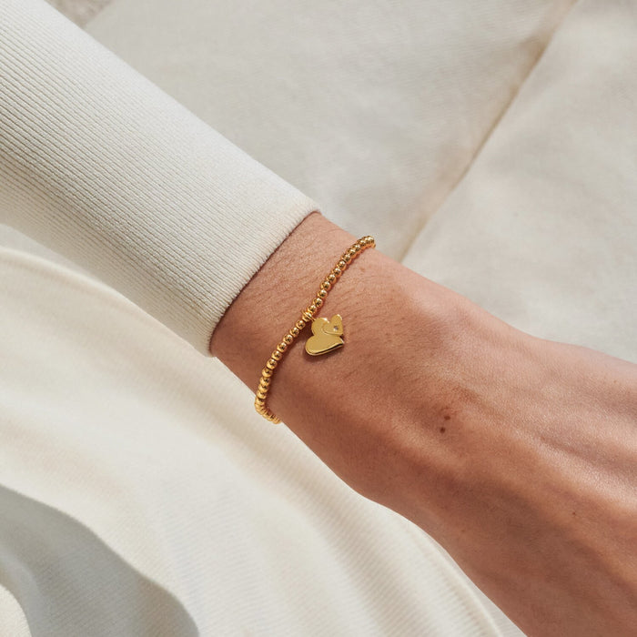 Gold-plated Joma Jewellery beaded Bracelet worn on wrist with double heart charm and tiny crystal detail, Mother & Daughter Bracelet gift.