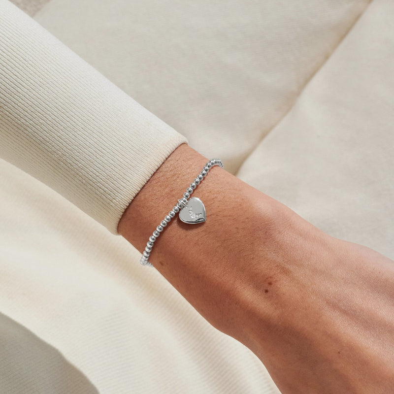 Silver-plated Joma Jewellery beaded Bracelet worn on wrist with heart charm and crescent moon detail, Mother’s Day gift for Mum.