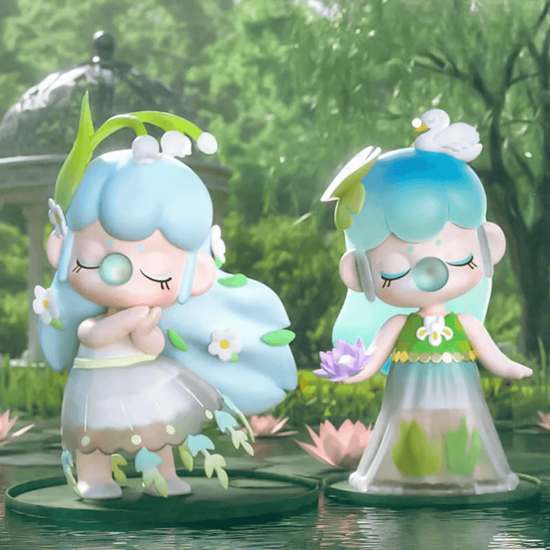 Two Little Pool figures on lily pads—one with flowing hair, one holding lotus blossom—in a woodland pond scene

