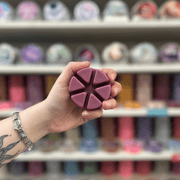 Nocturnal Freaks purple segmented wax melt held in hand