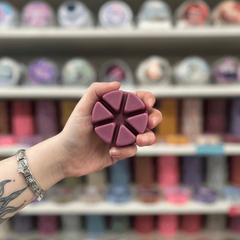 Nocturnal Freaks purple segmented wax melt held in hand