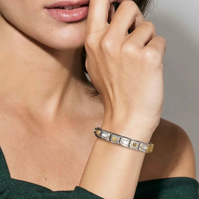 Woman wearing Nomination Composable Classic Bracelet styled with white opal and yellow-gold Links, lifestyle image.
