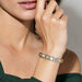 Woman wearing Nomination Composable Classic Bracelet styled with white opal and yellow-gold Links, lifestyle image.