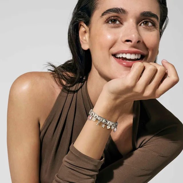 Model wearing Nomination Bracelet styled with silver star pendant Links and charms.