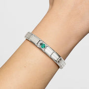 Green teardrop cubic zirconia Nomination Classic Link with white CZ cluster shown on a Composable Nomination bracelet worn on wrist