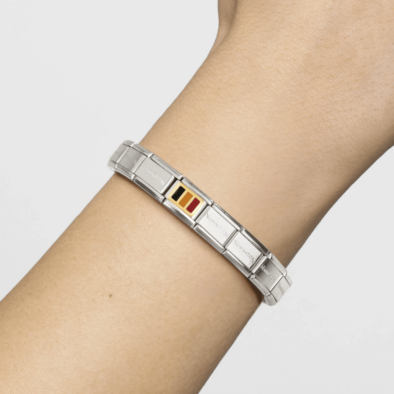 Nomination Classic stainless steel bracelet worn on the wrist featuring the gold Belgium Flag Link with black, yellow and red enamel.