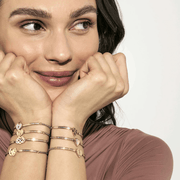 Nomination Milleluci gold-tone and silver-tone bracelets worn together