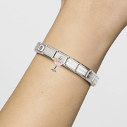 Nomination Classic stainless steel Composable bracelet worn on wrist with dangling pink cocktail glass charm