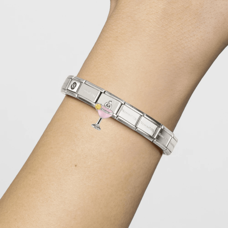 Nomination Classic stainless steel Composable bracelet worn on wrist with dangling pink cocktail glass charm