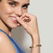 Model wearing a Nomination Pretty Bangles Yellow PVD bracelet with oval rose Cubic Zirconia stones.