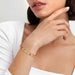 Model wearing a Nomination Pretty Bangles rigid chain bracelet in gold tone.