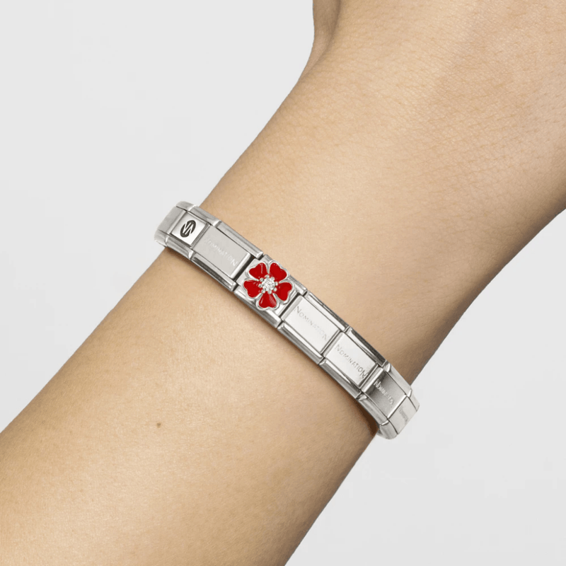 Nomination Classic Composable bracelet worn on the wrist featuring a red enamel flower charm with central white cubic zirconia.