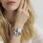 Model wearing a Nomination Sunray Sky Blue Watch with personalised Composable strap alongside a second silver-toned Nomination watch