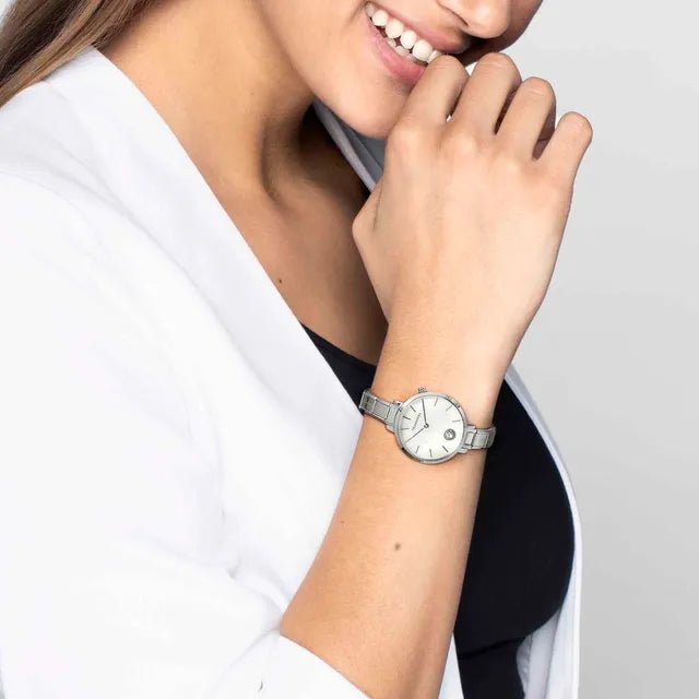 Woman wearing a Nomination Time round watch with white mother-of-pearl dial on a Composable strap.