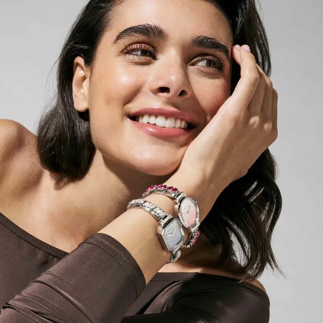 Lifestyle shot showing Nomination Time watches stacked with Composable Links bracelets.