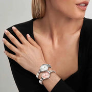 Model stacking Nomination Time watches, including an oval MOP style, on Composable Classic Link straps.