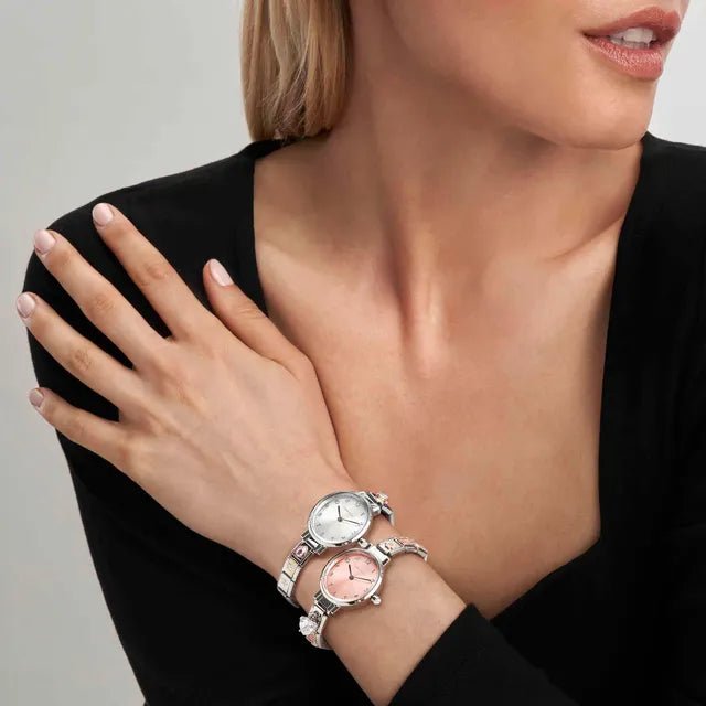 Model stacking Nomination Time watches: round white MOP and pink dials on Composable straps.