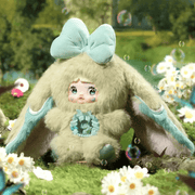 Nepenthe plush – sage‑green suit, aqua bow and butterfly core, Nommi Fantasy World collectable.
