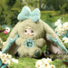 Nepenthe plush – sage‑green suit, aqua bow and butterfly core, Nommi Fantasy World collectable.
