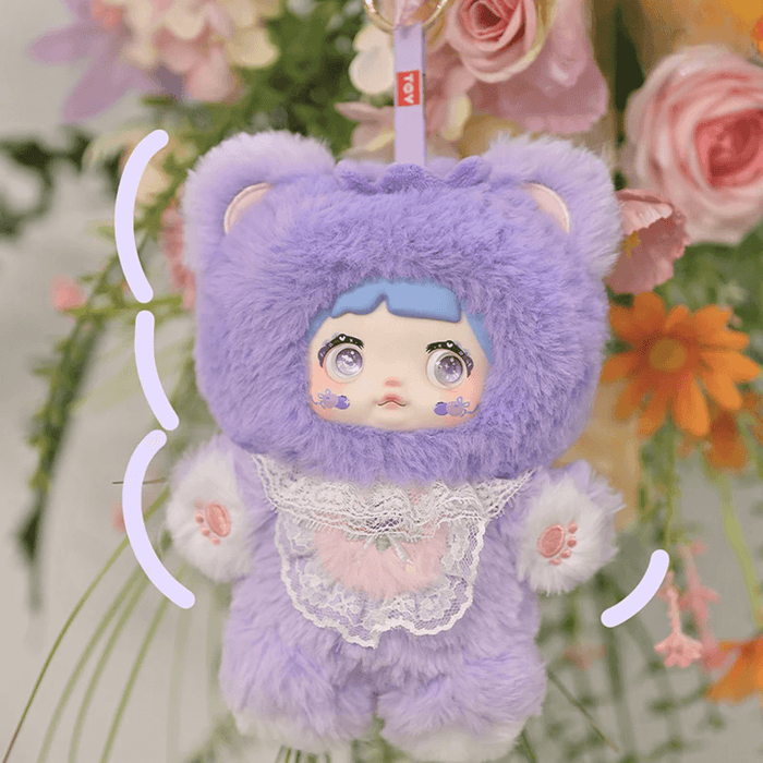 Blueberry Nommi – lavender bear suit, sky‑blue fringe and lace collar with blueberry patch.
