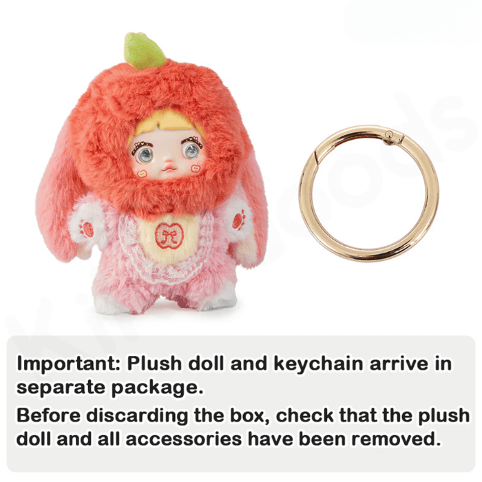 Apple Nommi plush beside separate gold keyring; text warns to remove all parts before discarding packaging.

