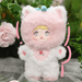 Strawberries Nommi – white suit with rosy‑pink hood, embroidered berry bib and cat ears.
