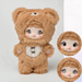 Cookie Bear QUQI plush in toffee fur, stitched snout and cross‑lace belly badge; two eye modes shown.
