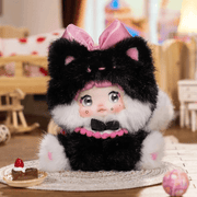 Strawberry Oopsie Nommi Sitting Zoo plush wearing a fluffy black cat costume