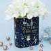 The Nutcracker book vase with white flowers on pale blue background and baubles