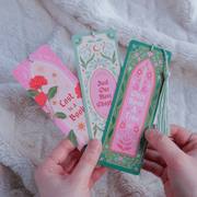 Once Upon A Time bookmark held in hands showing floral green and pink design