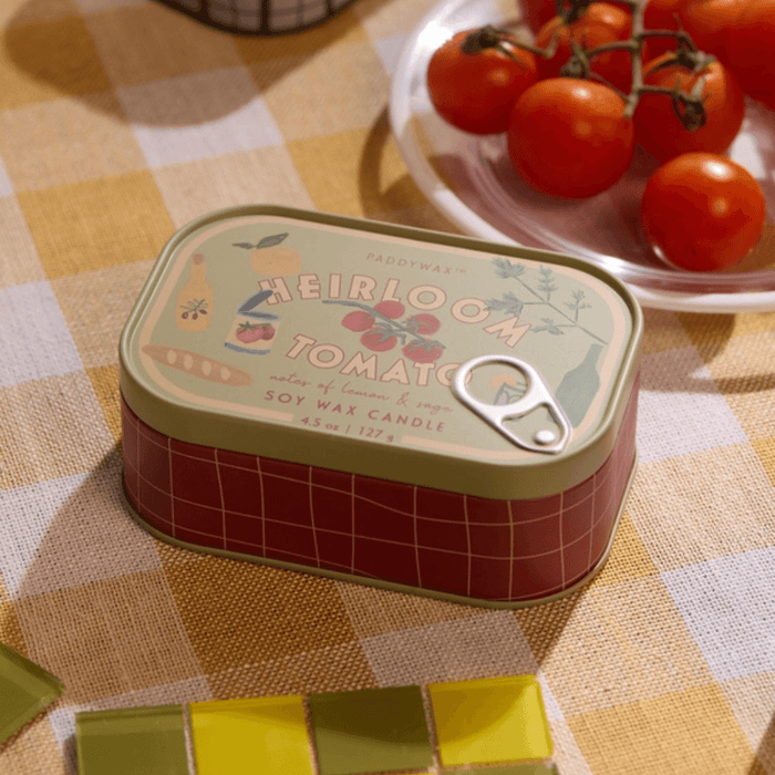 Paddywax Bistro Heirloom Tomato tin candle on a checked tablecloth with fresh tomatoes
