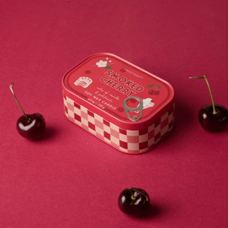 Paddywax Bistro Smoked Cherry tin candle displayed with fresh cherries