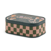 Side view of Paddywax Bistro Wild Mushroom tin candle with green checkerboard design
