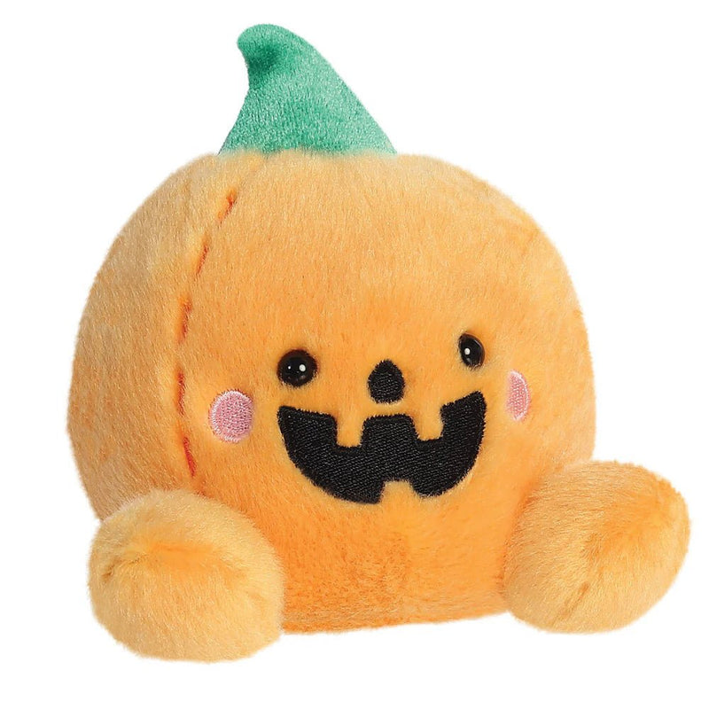Angled view of Palm Pals pumpkin plush with black smile and pink cheeks

