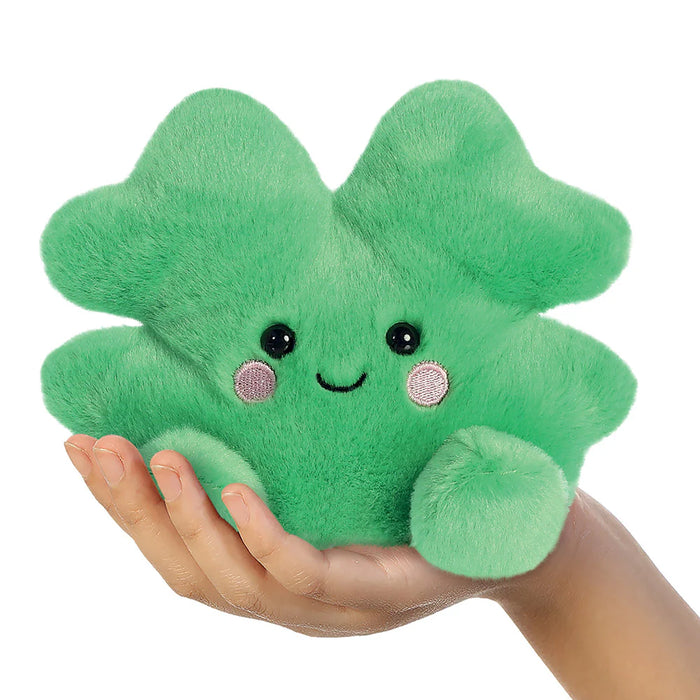 Palm Pals Chance Clover plushie held in hand to show pocket-sized 13cm scale