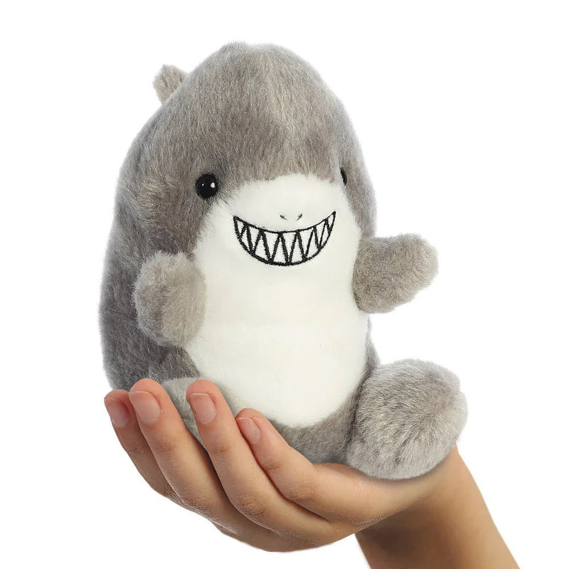 Palm Pals Chomps Shark plush toy held in a hand for size reference.

