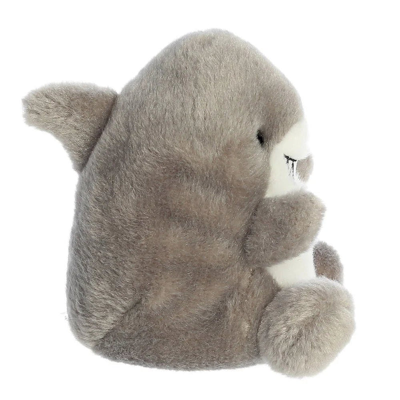 Side view of Palm Pals Chomps Shark plush toy showing fins and rounded shape.

