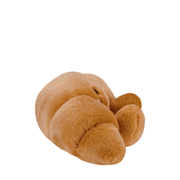 Side view of Palm Pals Colette Croissant golden brown plush toy
