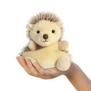 Palm Pals Hedgie Hedgehog 13cm plush shown in hand to indicate pocket size and squishy shape.