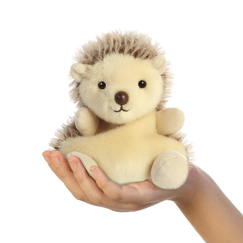 Palm Pals Hedgie Hedgehog 13cm plush shown in hand to indicate pocket size and squishy shape.