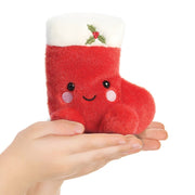 Holly Stocking Palm Pals plush shown in hands to illustrate 13cm size
