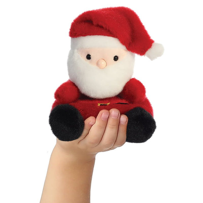 Santa Claus Palm Pals plush shown in hand to illustrate 13cm size