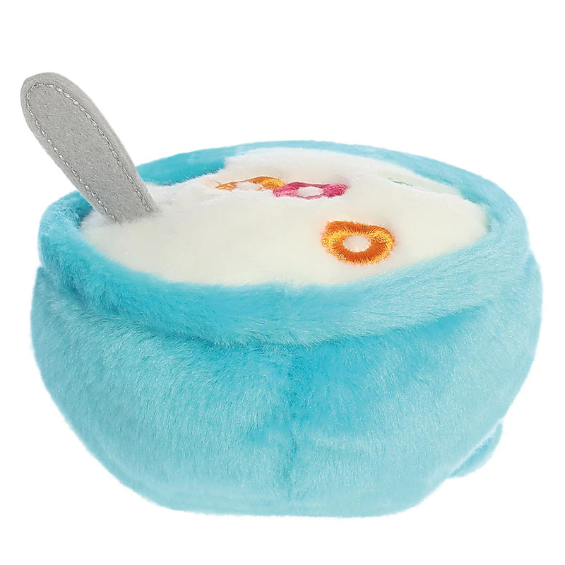 Angled top view of Palm Pals Trixie Cereal plush toy with embroidered cereal loops