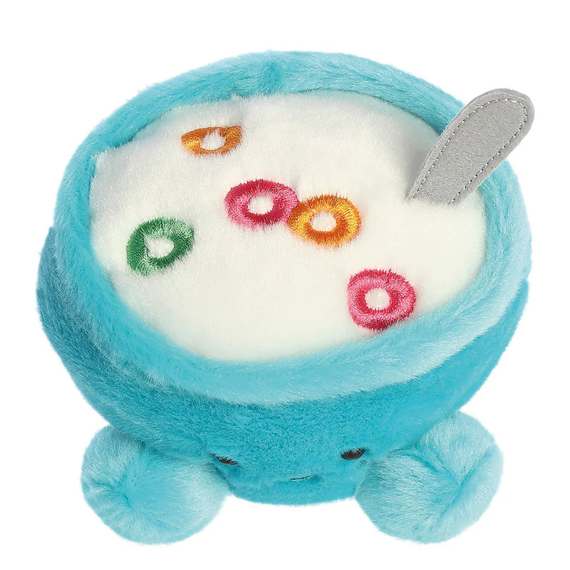 Angled top view of Palm Pals Trixie Cereal plush toy with embroidered cereal loops